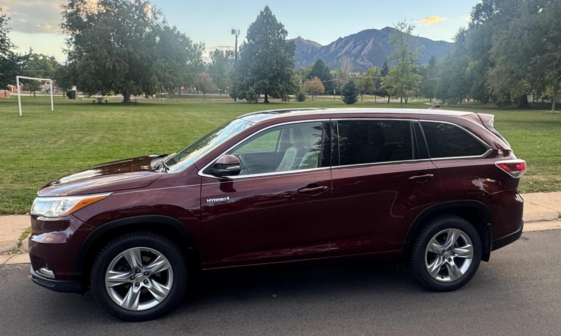 2015 Red /Tan Toyota Highlander Hybrid Limited AWD (5TDDCRFH9FS) with an 3.3L V6 DOHC 24V HYBRID engine, Continuously Variable Transmission transmission, located at 2510 47th St. Suite 200, Boulder, CO, 80301, (303) 641-0333, 40.026196, -105.243217 - This Beautiful 2015 Toyota Highlander Hybrid Limited is a recent acquisition by Boulder Motors. It is finished in Toyota’s Ooh La La Rouge Mica with Almond Perforated Leather. The Colorado title is Clean Clear. Some Features: Color-keyed rear spoiler with LED center high-mount stop light · - Photo#0