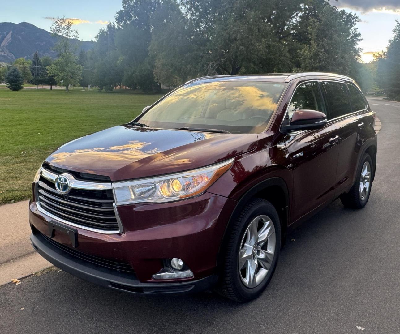 2015 Red /Tan Toyota Highlander Hybrid Limited AWD (5TDDCRFH9FS) with an 3.3L V6 DOHC 24V HYBRID engine, Continuously Variable Transmission transmission, located at 2510 47th St. Suite 200, Boulder, CO, 80301, (303) 641-0333, 40.026196, -105.243217 - This Beautiful 2015 Toyota Highlander Hybrid Limited is a recent acquisition by Boulder Motors. It is finished in Toyota’s Ooh La La Rouge Mica with Almond Perforated Leather. The Colorado title is Clean Clear. Some Features: Color-keyed rear spoiler with LED center high-mount stop light · - Photo#2